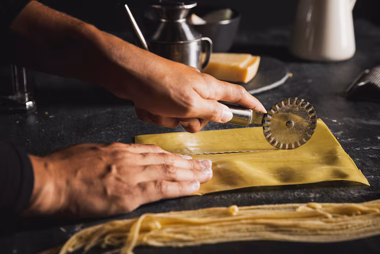 close-up-hands-with-pizza-cutter-utensils_23-2148296890